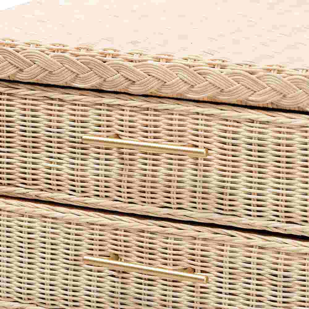 Close-up of woven rattan drawer fronts on sun-bleached nightstand