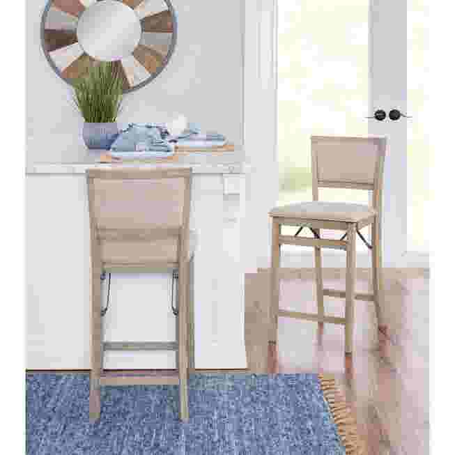 Two grey wash folding bar stools in a kitchen setting