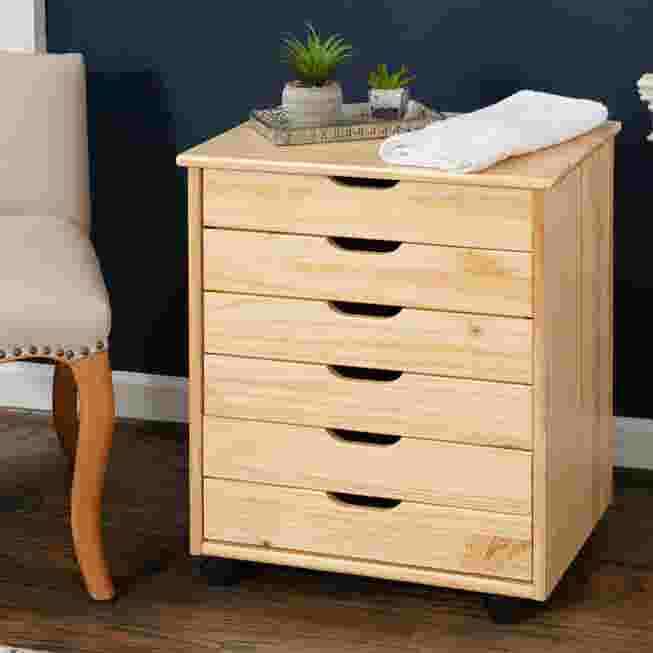 Light wood rolling storage cart with six drawers in a room setting.