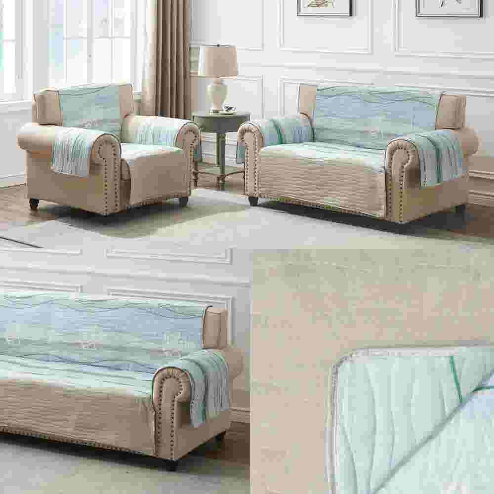 Two beige sofas with blue quilted protectors in a showroom setup