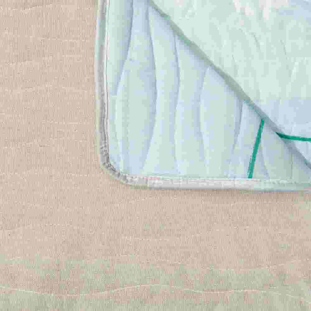 Close-up of fabric edge and stitching of quilted protector