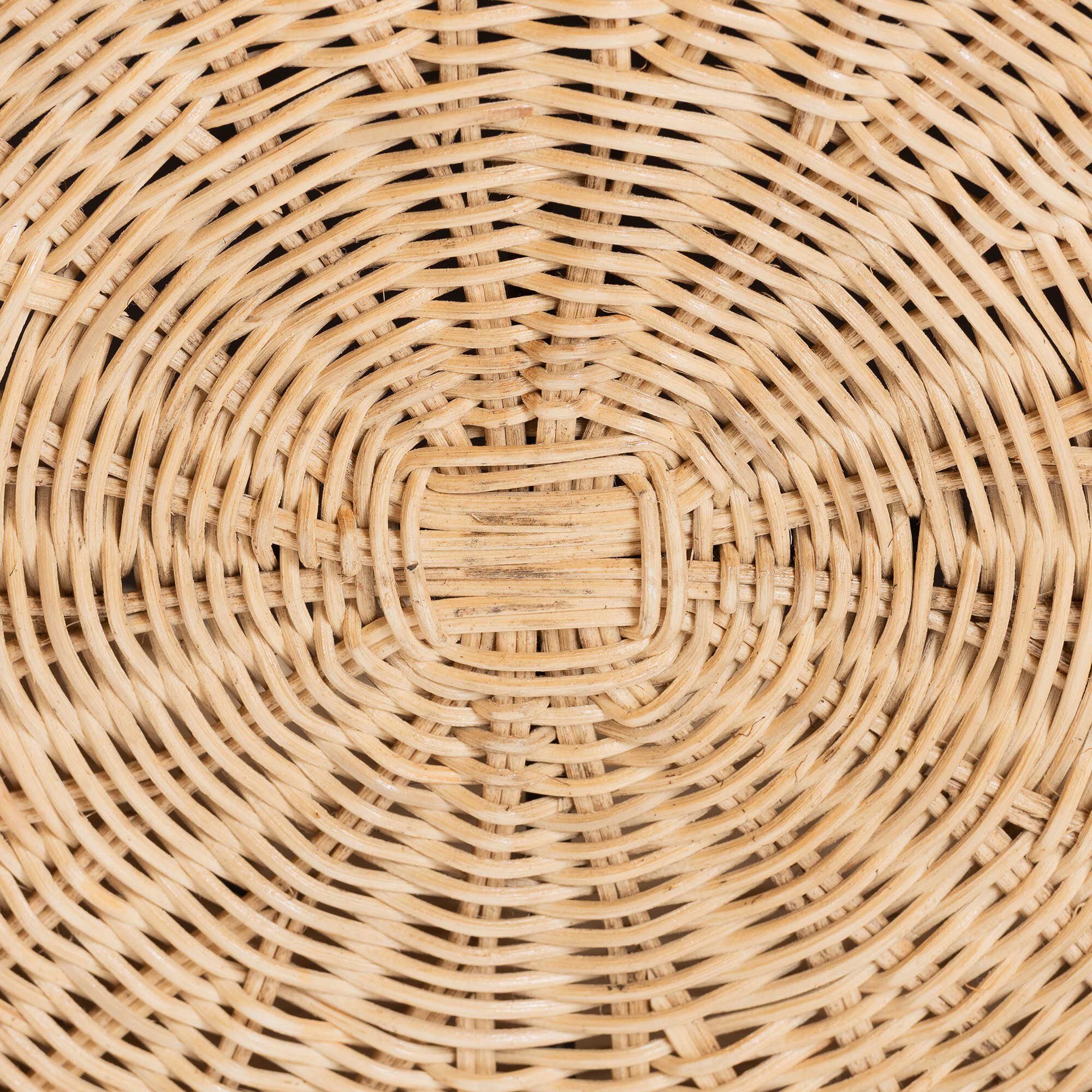 Close-up of the woven rattan pattern on the ottoman base