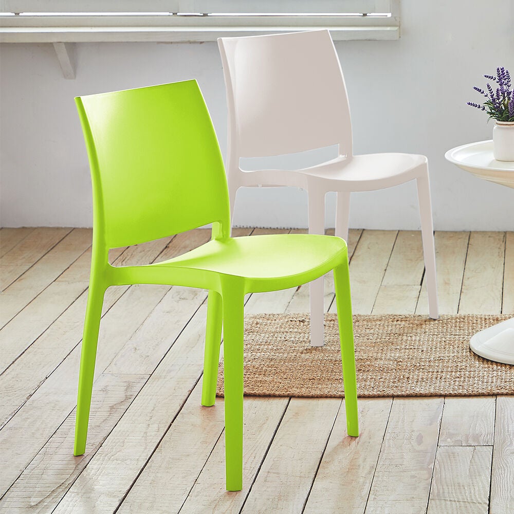 Lime green stackable outdoor dining chair near outdoor seating.