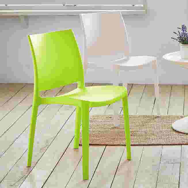 Lime green stackable outdoor dining chair near outdoor seating.