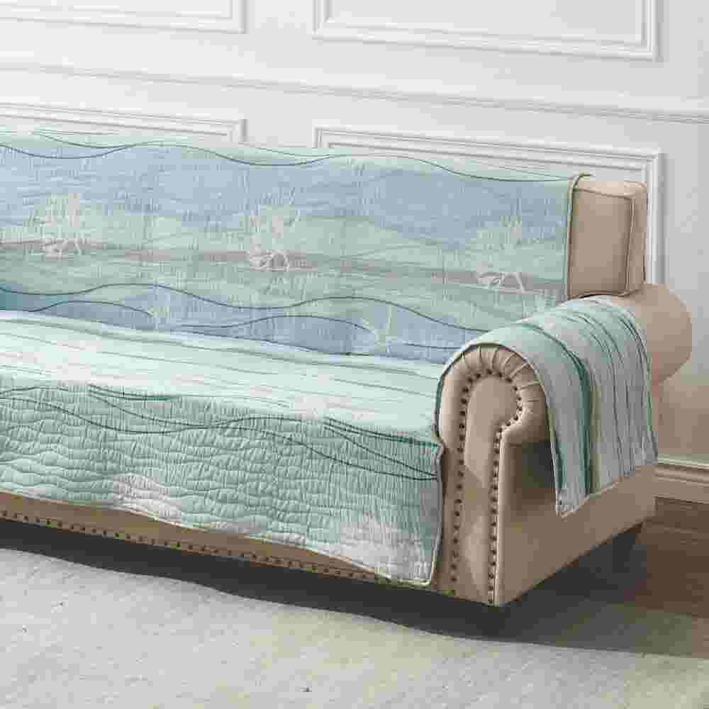 Close-up side angle of quilted blue protector on sofa