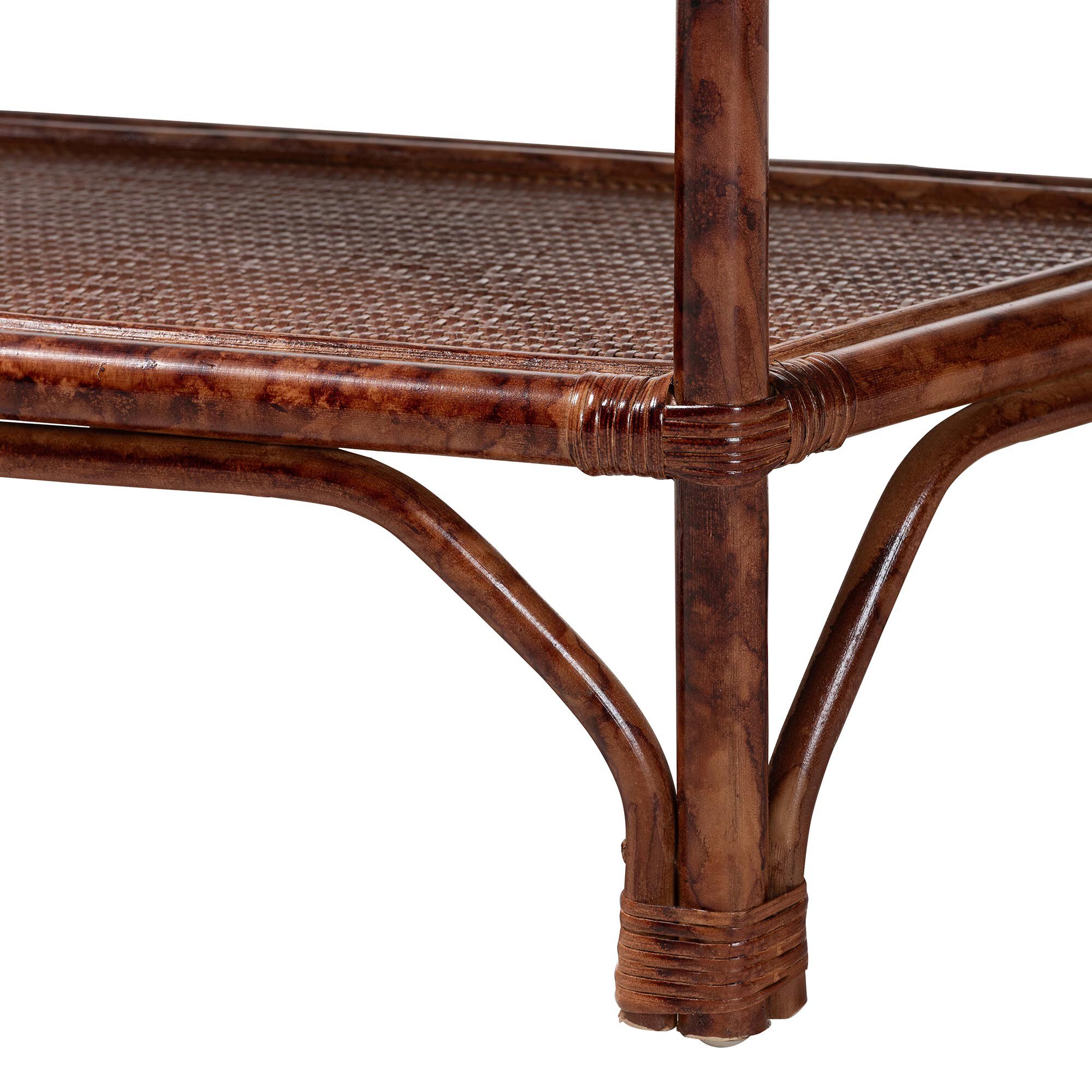 Close-up of the lower shelf and leg of the rattan console table.