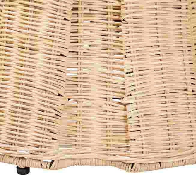 Close-up of the woven rattan base and small black feet of the ottoman