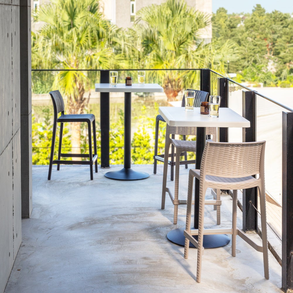Pair of outdoor stackable counter stools in woven light gray/stone finish